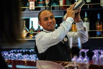 Fred.Olsen Cruise Lines Waiter serving a Martini Cocktail.jpg